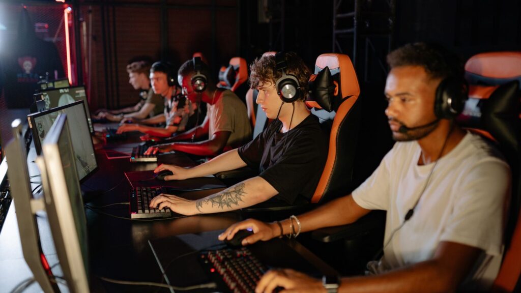 Competitive PC gamers playing at desktop gaming stations