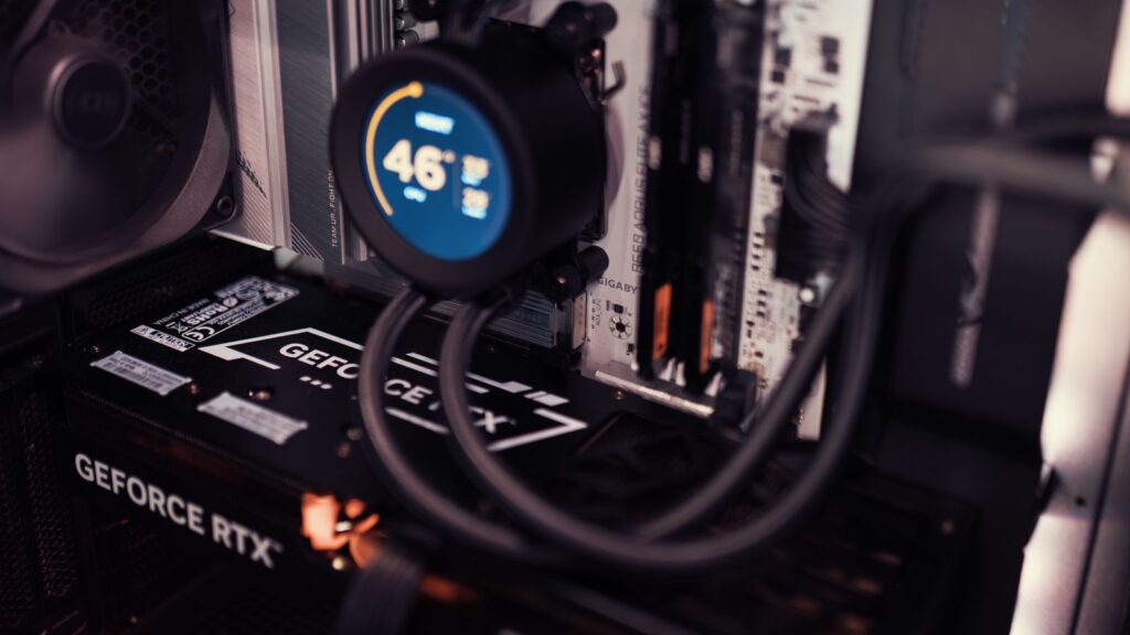 Close-up of a GeForce RTX graphics card and cooling hardware inside a gaming PC.