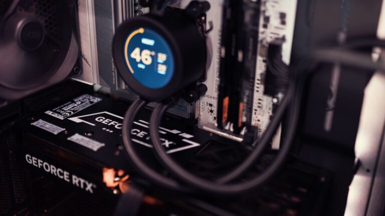 Close-up of a GeForce RTX graphics card and cooling hardware inside a gaming PC.